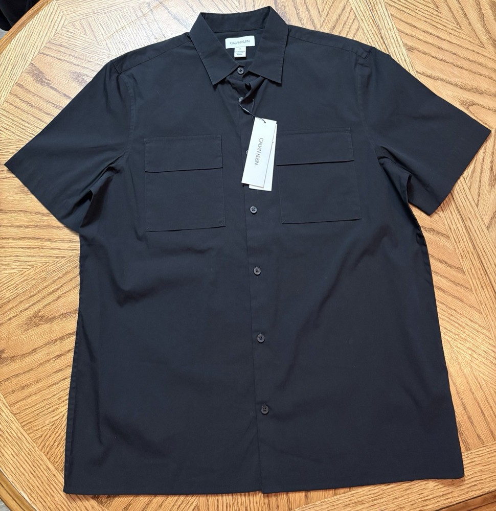 New With Tags. Calvin Klein Black Button Down T-shirt. Size Medium.