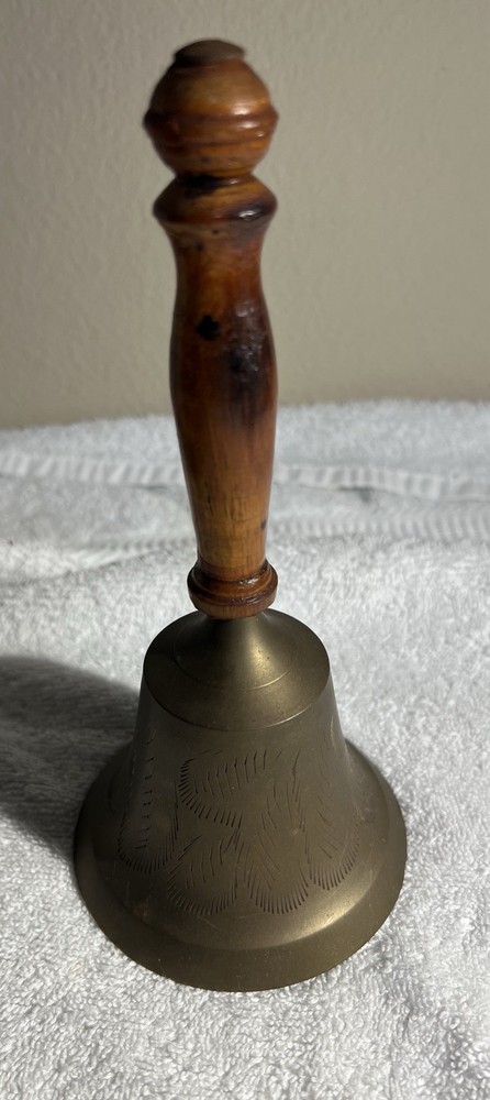 vintage etched brass hand bell with a contoured wooden handle