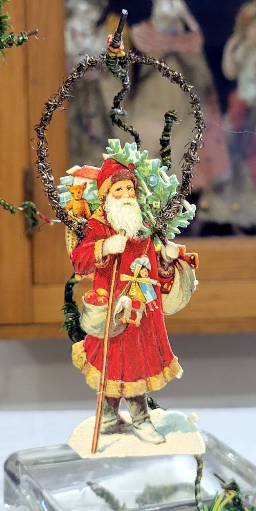 Red robed Santa, with Oranges & Toys. Miniature Silver Tinsel & Paper Orn