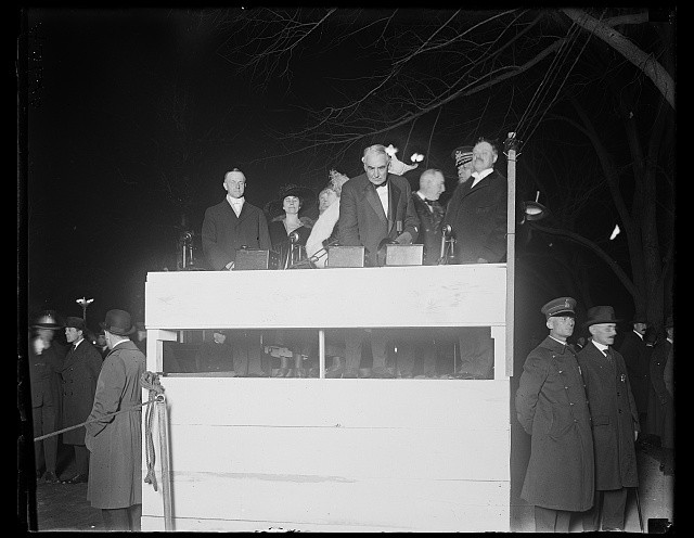 Outdoor stand with Calvin Coolidge, Grace Coolidge, Florence Harding and Warren
