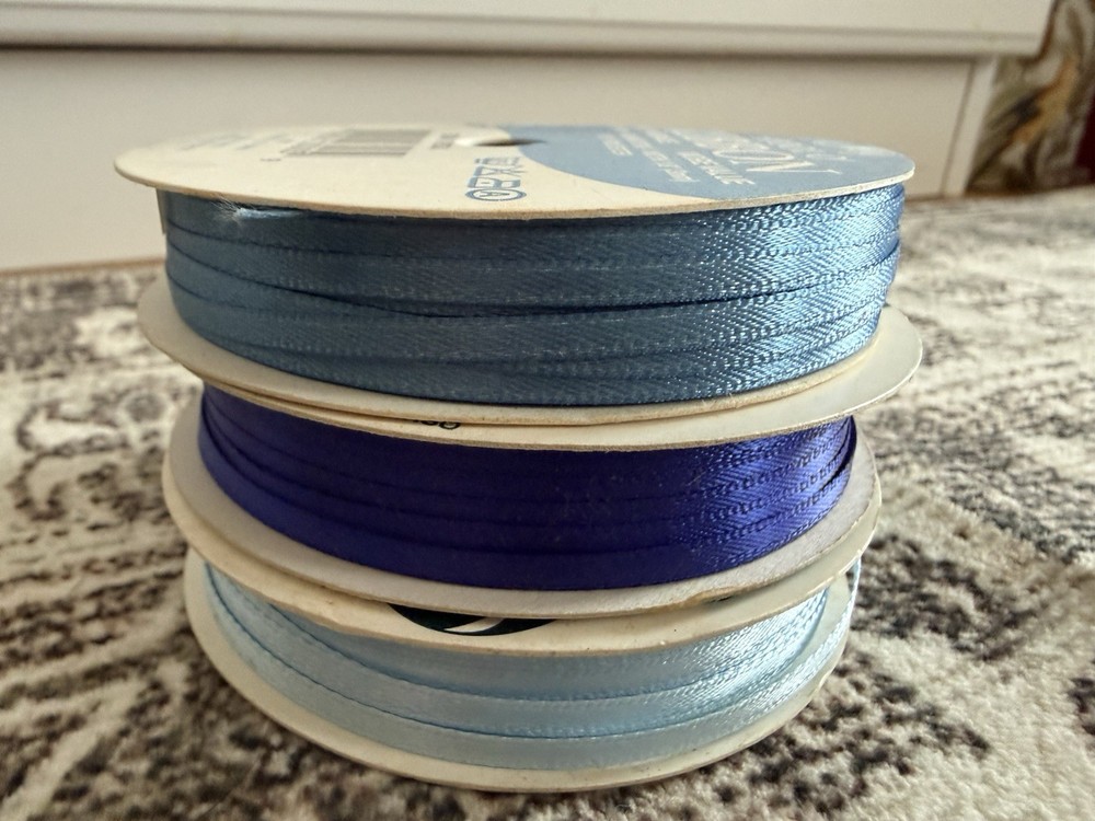 Three rolls of blue ribbon bundle