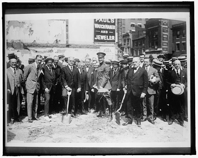 Group With Shovels at Groundbreaking Ceremony Watchmaker and Jeweler Sign