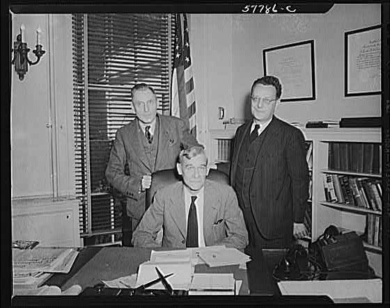 Photo:Office Men Portrait 1930s Desk American Flag Bookshelves