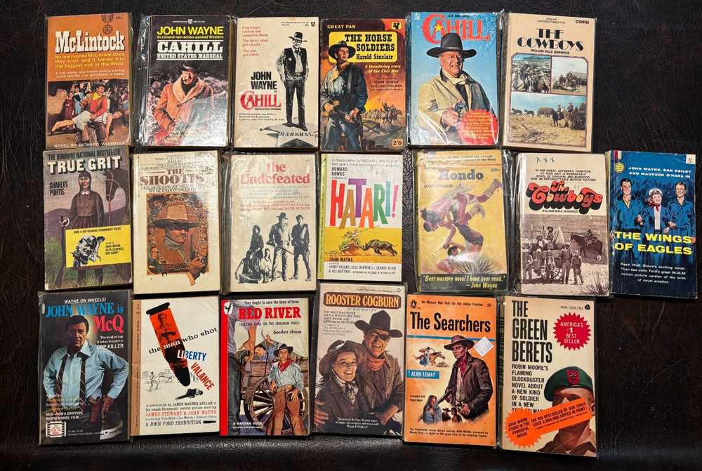 19 John Wayne movie tie-in papebacks 1940s on VG Red River-McLintock-Cahill etc