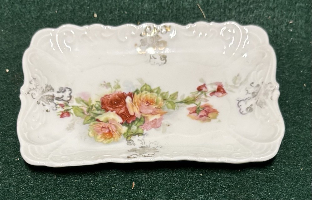 This is an antique or vintage porcelain celery or relish dish