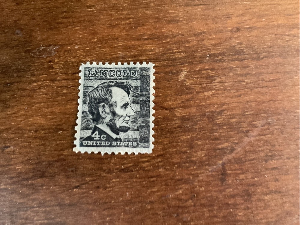 Black 4-cent United States postage stamp featuring Abraham Lincoln Unused