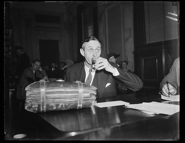 Photo:New York City NY 1930s Man at Table Drinking Water Press Conference