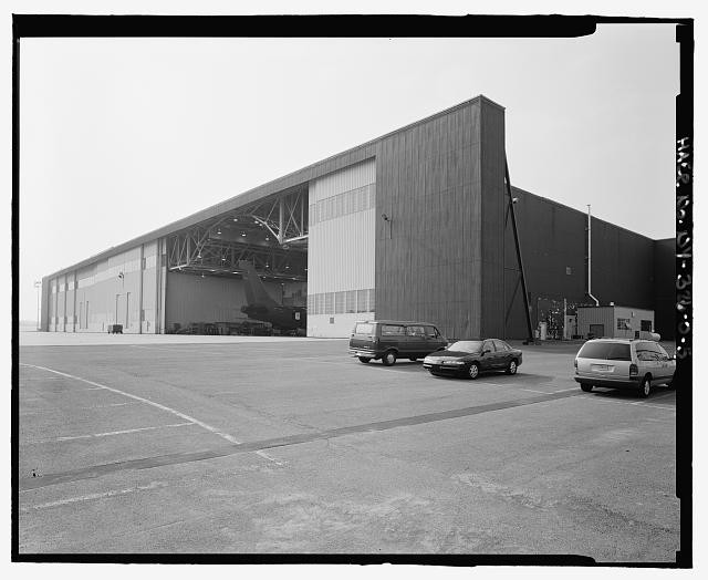 Detail Of South And East Elevations Of Building, Showing Open Hangar Door. View