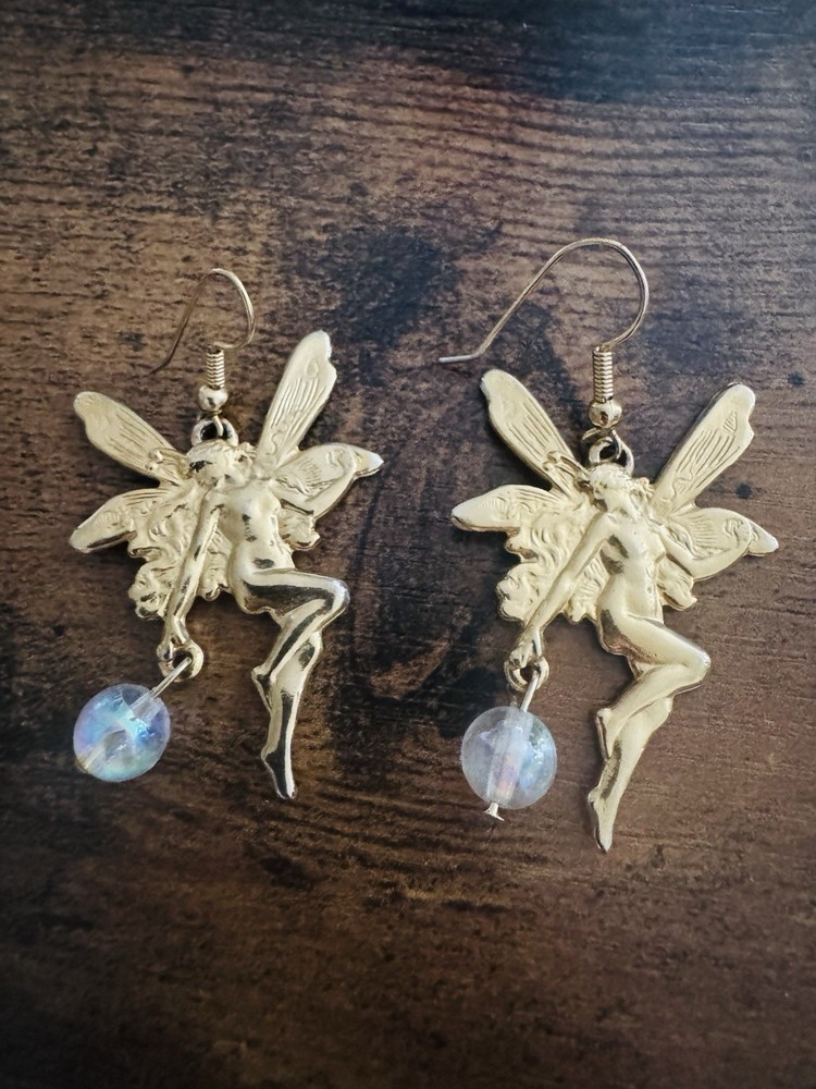 gold-tone fairy earring with a clear bead drop.