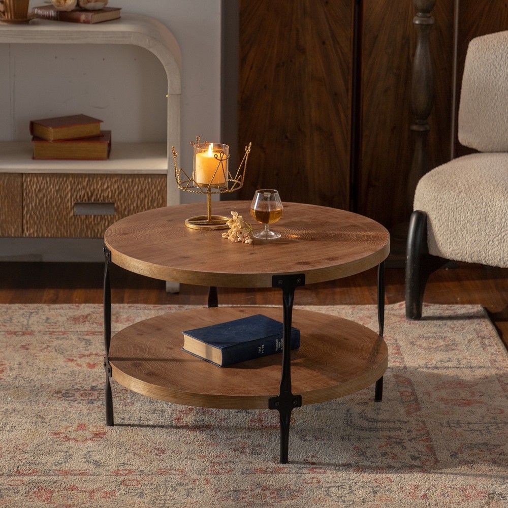 A circular, two-tiered coffee table with a hand-carved, sturdy base.