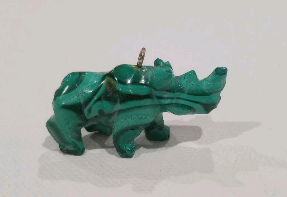 Pendant malachite a hand-carved rhinoceros figurine made from  stone