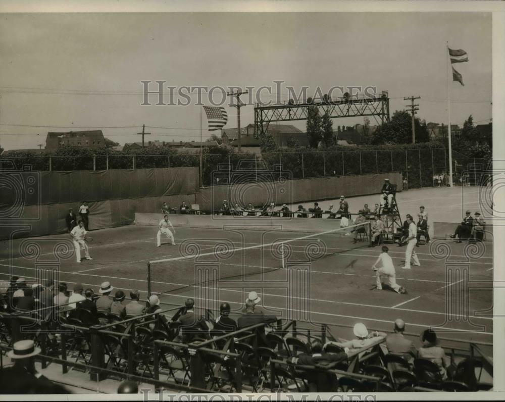 1932 Press Photo US tennis doubles versus another team in action on courts